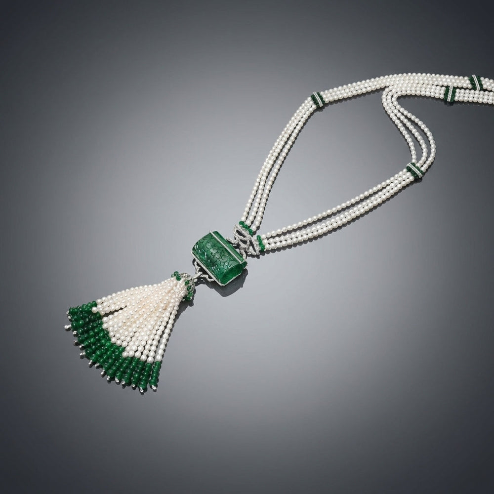 Luxurious Colombian emerald and freshwater pearl sautoir necklace displayed on glossy gradient grey background, emphasizing elegance and jewelry quality.