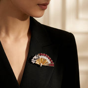 Elegant East Asian female model wearing a Fanfare Ruby & Diamond Brooch on black dress in luxury jewelry photoshoot setting.