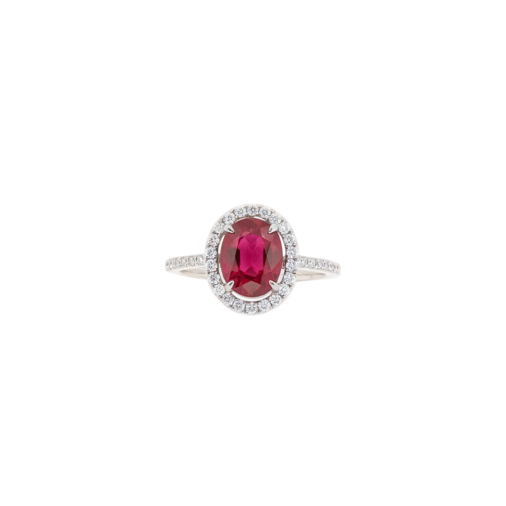 Ring with a red gemstone and diamond accents on a white background